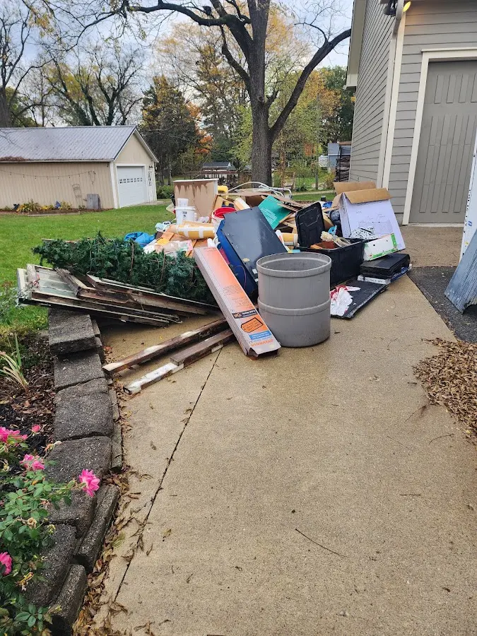 Dumpster being loaded with debris for Estate Cleanout Dumpster Rental in Kermit
